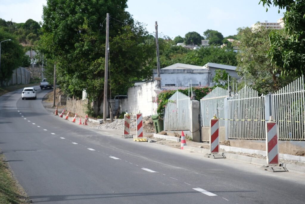 Ongoing Beautification and Infrastructure Upgrades by VROMI Dutch St Maarten
---
VROMI Pushes Forward with Key Infrastructure Upgrades
The Ministry of VROMI continues its mission to beautify and upgrade public spaces. These latest works focus on safety, accessibility, and long-term infrastructure improvement.
---
New Retaining Wall Enhances Road Safety
Crews completed a solid retaining wall at the T-junction of Hulda B. Richardson Road and Bishop Hill Road.
This wall prevents erosion. It stops dirt, soil, and rocks from sliding down the hillside. As a result, the road remains clear and safe for both drivers and pedestrians.
---
Schrikhekkens Installed for Better Visibility
To increase road clarity, workers installed two Dutch-style schrikhekkens at the same junction.
These highly reflective barriers mark the left and right turns. Therefore, drivers can now see and respond faster—especially at night or during bad weather.
---
Sidewalk Installation Improves Pedestrian Access
Pedestrian safety remains a priority.
✅ New sidewalks are now in place at the T-junction of Hulda B. Richardson and Bishop Hill Road.
✅ Work continues along A.T.H. Illidge Road.
✅ Sidewalks on Sucker Garden Road are nearly complete.
Each step creates safer walkways and encourages foot traffic in busy areas.
---
Commitment to a Safer, Cleaner St. Maarten
These upgrades do more than improve infrastructure. They support VROMI’s larger goal—to build a better, safer St. Maarten.
In the meantime, we thank the Infrastructure Department and contractors for their dedicated efforts.
Also, we thank the public for its continued patience and cooperation. Your support makes these improvements possible.
---
Progress in Motion
As these projects move forward, VROMI remains committed to clean, safe, and accessible roads for all.
Let’s keep St. Maarten moving in the right direction—together.
---
#VROMI #BeautificationProject #RoadSafety #InfrastructureUpgrade #SidewalksInstallation